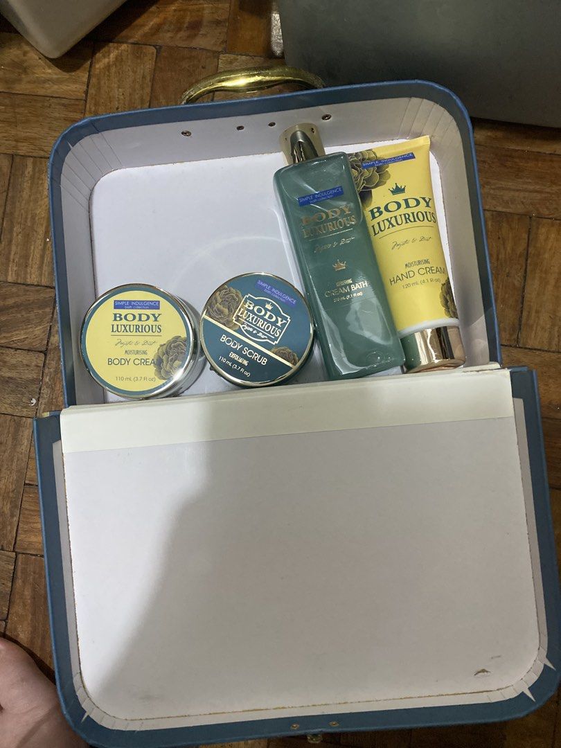 Simple Indulgence Body Luxurious Bath Collection Gift Set Box (Category: Bath) located in Manila. Submitted by solonglondon (Listing ID 1470058940, Image 1). Description: - Brand new, unused bath and body gift set - Comes in a reusable blue decorative suitcase with gold handles and a floral motif - Mystic and Duet scent - Set includes: - Body Cream (110 ml) - Body Scrub (110 ml) - Cream Bath (270 ml) - Moisturizing Hand Cream (120 ml) - Ideal gif