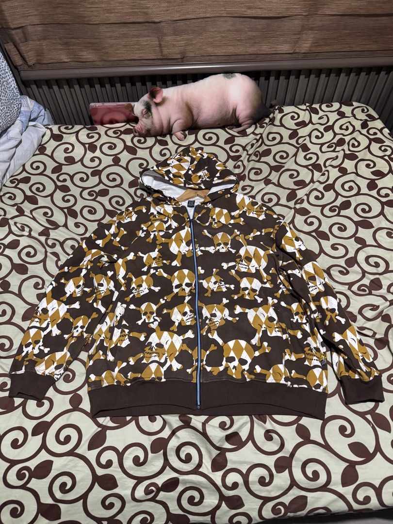 Skull pattern brown zip up hoodie (Category: Hoodies) located in Manila. Submitted by cruzcraven63055 (Listing ID 1470051325, Image 1). Description: - Design: Brown with all-over skull, crossbones, and white checkerboard print - Closure: Full front zipper - Features: Hood with white inner lining, ribbed cuffs and hem for warmth - Material: Soft and comfortable fabric - Style: Bold streetwear piece, ideal for cooler weather.