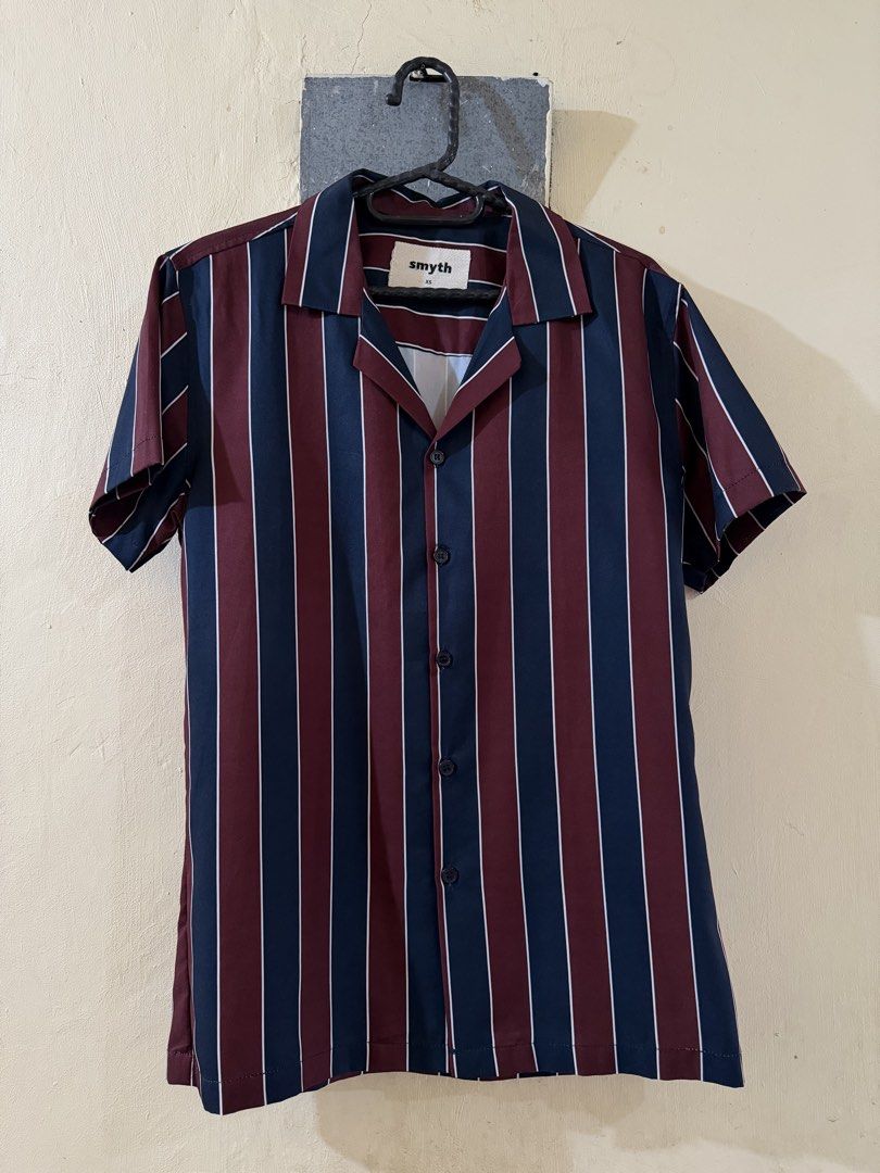 Smyth Striped Short Sleeve Shirt (Category: Tshirts & Polo Shirts ) located in Las Pinas. Submitted by rareriroruru (Listing ID 1470055876, Image 1). Description: - Brand/Style: Smyth button-down shirt with camp collar - Color/Pattern: Maroon and navy blue with white vertical stripes - Details: Short sleeves and front button closure - Size: XS - Length: 265.5 in - Width: 18 in - Condition: Clean, EUC with no stains or damage.