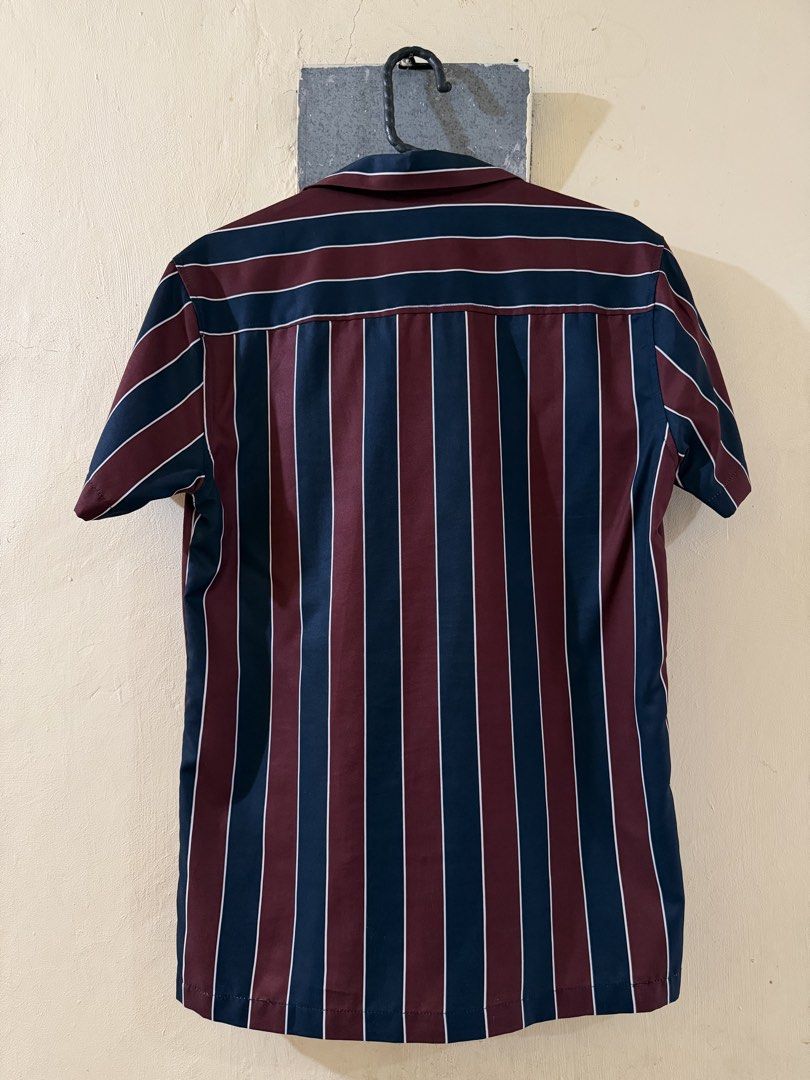 Smyth Striped Short Sleeve Shirt (Category: Tshirts & Polo Shirts ) located in Las Pinas. Submitted by rareriroruru (Listing ID 1470055876, Image 2). Description: - Brand/Style: Smyth button-down shirt with camp collar - Color/Pattern: Maroon and navy blue with white vertical stripes - Details: Short sleeves and front button closure - Size: XS - Length: 265.5 in - Width: 18 in - Condition: Clean, EUC with no stains or damage.