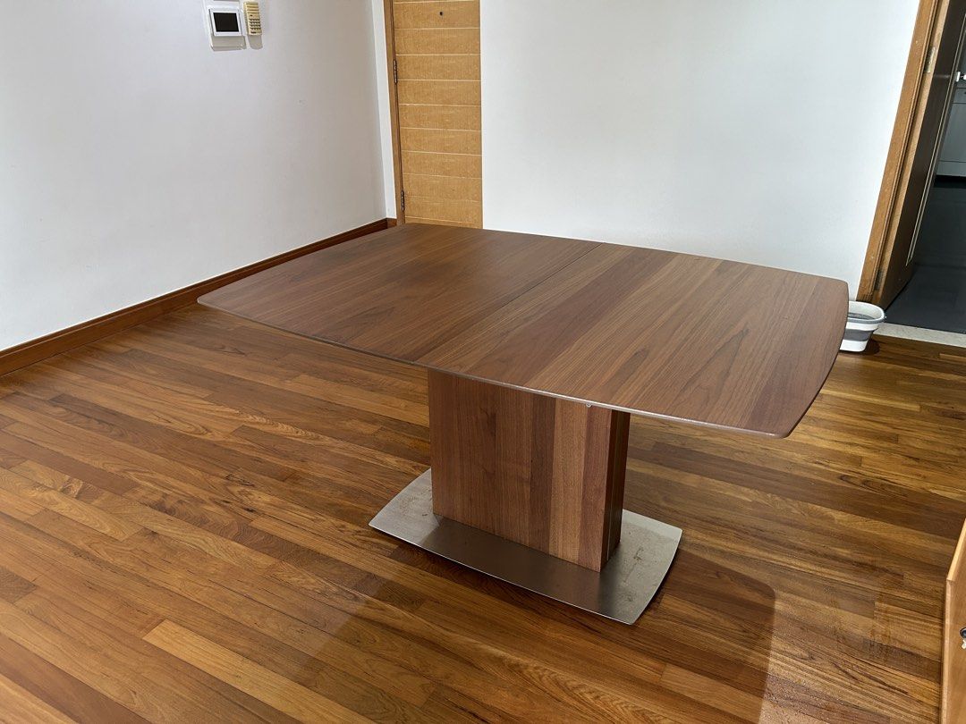 Solid wood dining table (Category: Tables & Sets) located in Singapore. Submitted by calchlch (Listing ID 1469987253, Image 2). Description: High quality dining table, extendable to cater for 2 more seats. Solid base that will never rock. High quality wood and solid steel..
