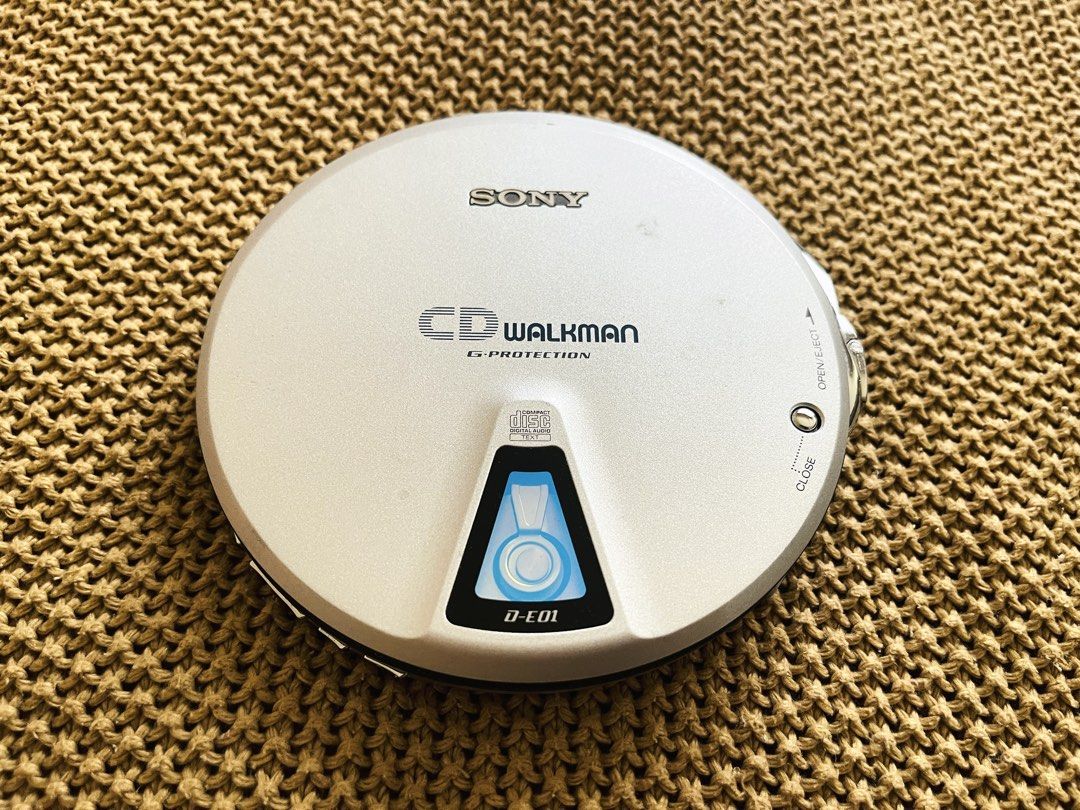 Sony CD Walkman D-E01 Portable Player (Category: Portable Music Players) located in Rizal. Submitted by ndvxvnty (Listing ID 1469962201, Image 1). Description: - Model: Sony CD Walkman D-E01 Portable Disc Player (Walkman’s 20th Anniversary CD player - released in 1999) - Slide in mechanism : Instert the CD through the little door to play the CD - Color: Silver - Power: 2 gum stick batteries (tested 2-3 hours playback time. Drains so much battery)