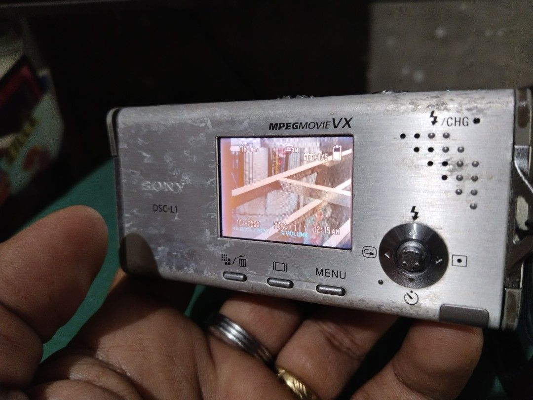 Sony Cyber-shot DSC-L1 Digital Camera (Category: Cameras) located in Manila. Submitted by megazordbuilderhunter (Listing ID 1470136823, Image 2). Description: - Model: Sony Cyber-shot DSC-L1 (Silver) - Condition: Powers on and displays menu correctly; has cosmetic wear and scuffs from past use - Specs: 4.1 Megapixels, 3x optical zoom, Carl Zeiss lens - Inclusions: Original battery, hand strap, and 16MB Memory Stick Duo - Perfect compact vintage d