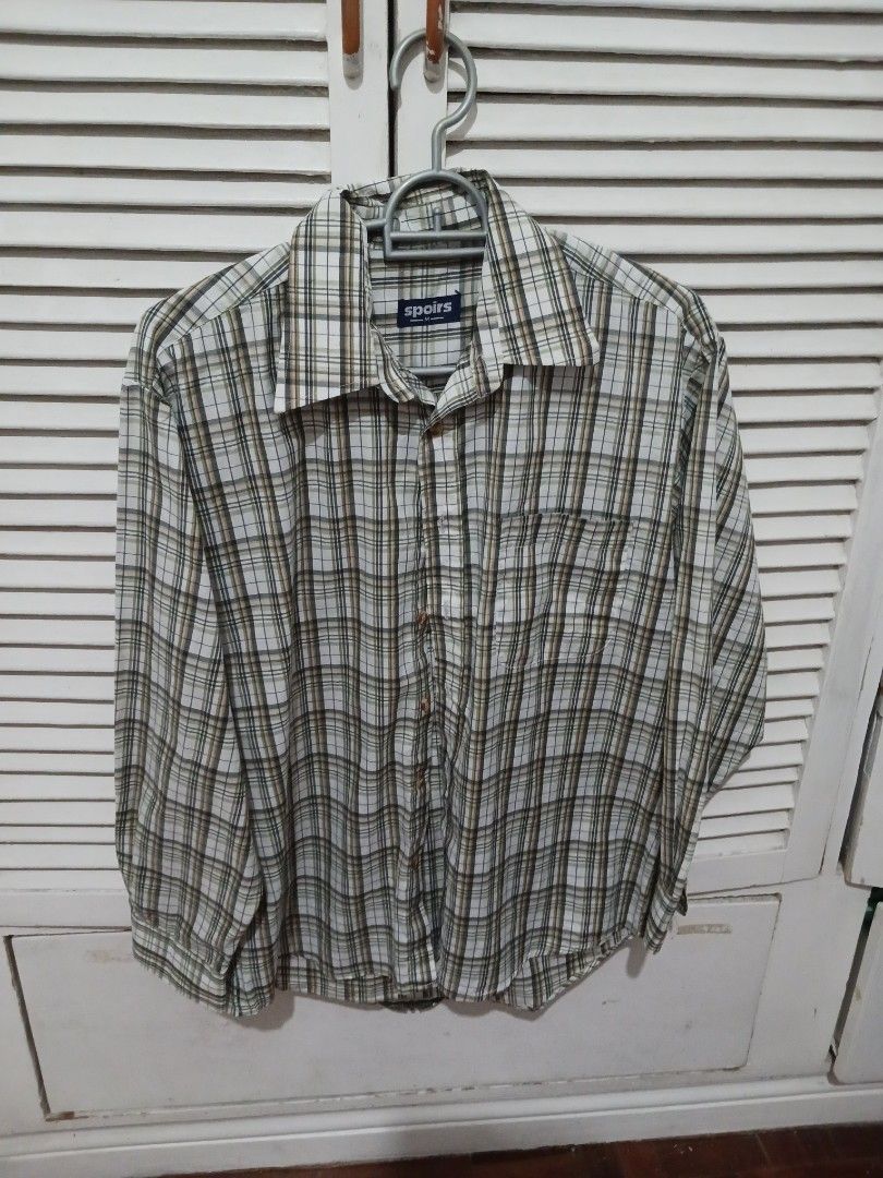 Spiors plaid long sleeve button up shirt medium (Category: Longsleeves) located in Quezon City. Submitted by rdonelle (Listing ID 1470095300, Image 1). Description: - Brand/Style: Spiors long sleeve button-up shirt - Pattern: Classic plaid in green, white, black, and peach tones - Size: Medium (tag on collar label) - Features: Standard front button closure with a single chest pocket - Condition/Use: Great for casual everyday wear or layering.