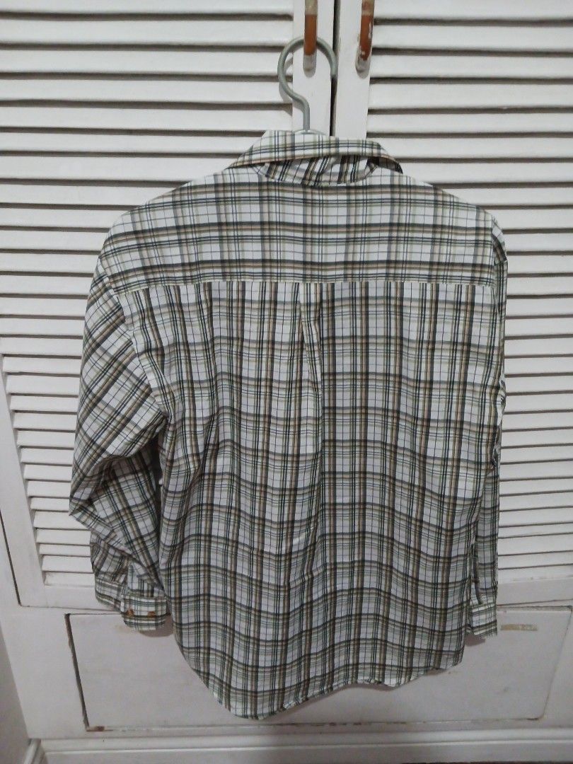 Spiors plaid long sleeve button up shirt medium (Category: Longsleeves) located in Quezon City. Submitted by rdonelle (Listing ID 1470095300, Image 3). Description: - Brand/Style: Spiors long sleeve button-up shirt - Pattern: Classic plaid in green, white, black, and peach tones - Size: Medium (tag on collar label) - Features: Standard front button closure with a single chest pocket - Condition/Use: Great for casual everyday wear or layering.