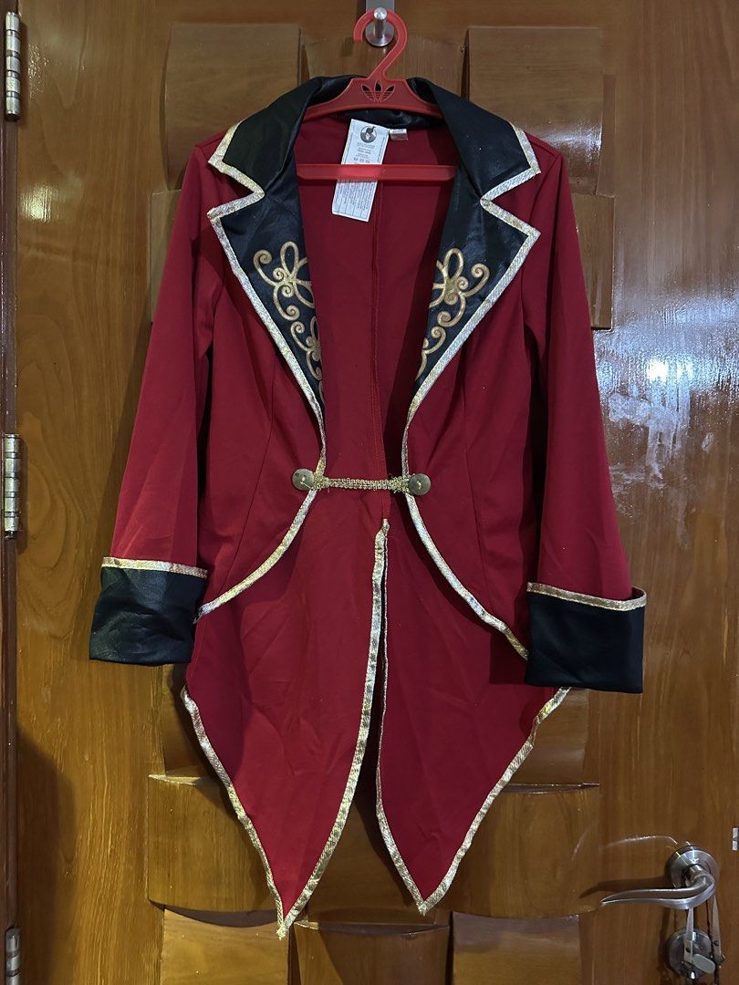 Spirit Halloween Red Ringmaster Coat Tween Large (Category: Babies & Kids Fashion) located in Muntinlupa City. Submitted by belica (Listing ID 1470092151, Image 1). Description: - Brand: Spirit Halloween - Size: Tween Large - Design: Red ringmaster jacket with swallowtail back, black collar and cuffs with gold trim, and gold scroll patterns on lapels - Material: 100% polyester (spot clean only) - Condition: Stored clean and ready to wear - Ideal 