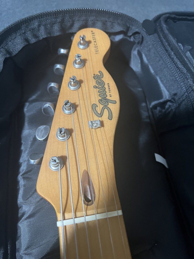 Squier 40th Anniversary Telecaster Electric Guitar (Category: Musical Instruments) located in Manila. Submitted by hanglooseguitars (Listing ID 1469973194, Image 3). Description: - Model: Squier 40th Anniversary Telecaster - Finish: Satin Brown with matching maple neck and fingerboard - Special Features: Commemorative neck plate - Inclusions: Fender guitar strap and gig bag - Condition: Solid setup, ready to plug in and play.