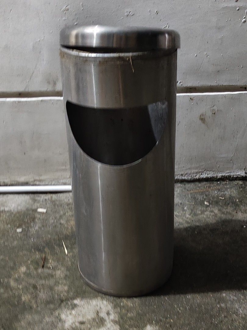 Stainless Steel Commercial Bin Dustbin with Side Opening (Category: Waste Bins & Bags) located in Bulacan. Submitted by babz30261 (Listing ID 1470098294, Image 2). Description: - Material: Heavy-duty stainless steel with sturdy metal construction - Design: Cylindrical shape featuring a large semicircular side opening and a removable top lid - Condition: Good and fully functional, with minor surface wear from previous use - Maintenance: Easy to wi