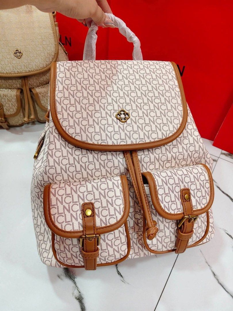 STELL CLN Monogram Print Backpack with Front Pockets (Category: Backpacks) located in Manila. Submitted by zosia_smith (Listing ID 1470013569, Image 2). Description: - Brand: CLN - Style: Monogram backpack - Available Colors: Beige and White - Closure: Flap closure with drawstring fastening - Storage: Dual front utility pockets with buckle straps - Accents: Elegant gold-tone hardware - Condition: Brand new with protective packaging on the top han