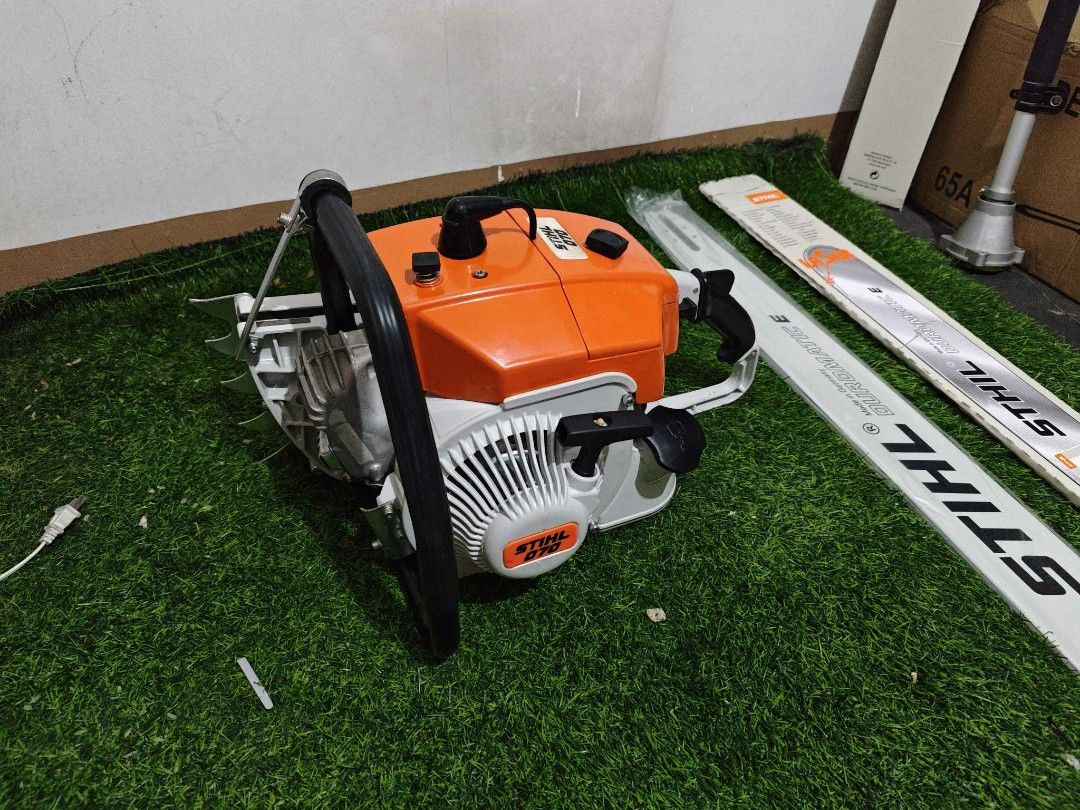 Stihl 070 Chainsaw with Duromatic E Guide Bar (Category: Construction Tools & Equipment) located in Valenzuela. Submitted by mysticgem.f63ae6 (Listing ID 1469955395, Image 3). Description: - Model: Stihl 070 Heavy-Duty Petrol Chainsaw - Color: Classic Orange and White - Engine: Powerful engine block with reliable pull start - Included Guide Bars: Stihl Duromatic E guide bar (wrapped in plastic) plus an additional boxed guide bar - Accessories: Ba