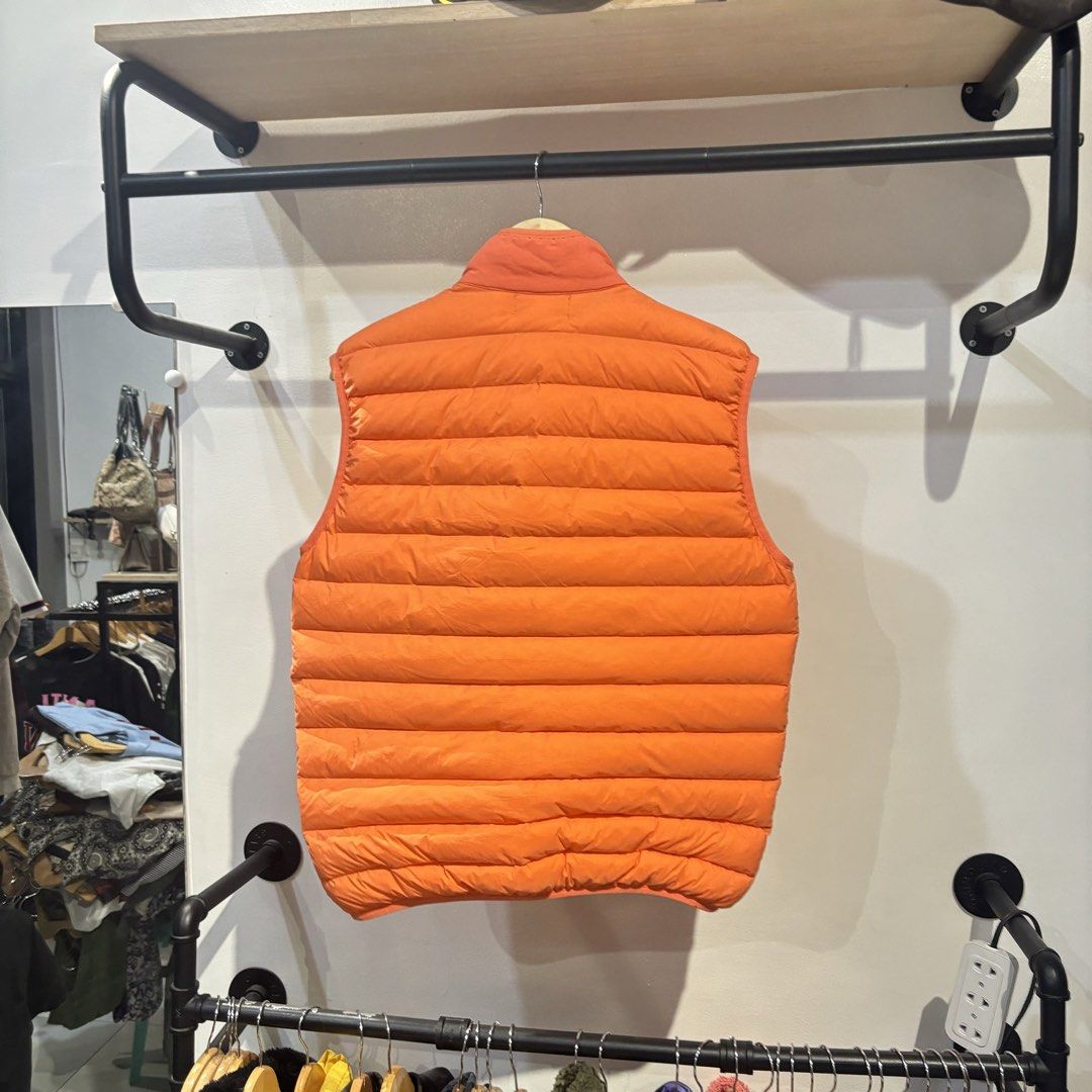Stone Island Orange Down Puffer Vest XL (Category: Vests) located in Bambang. Submitted by heats777 (Listing ID 1470003798, Image 3). Description: - Brand: Stone Island - Item: Puffer Vest - Color: Bright Orange - Size: XL - Details: Quilted down design, full zip front, stand collar, two side pockets - Branding: Iconic compass logo patch on left chest - Condition: Clean inside and out.