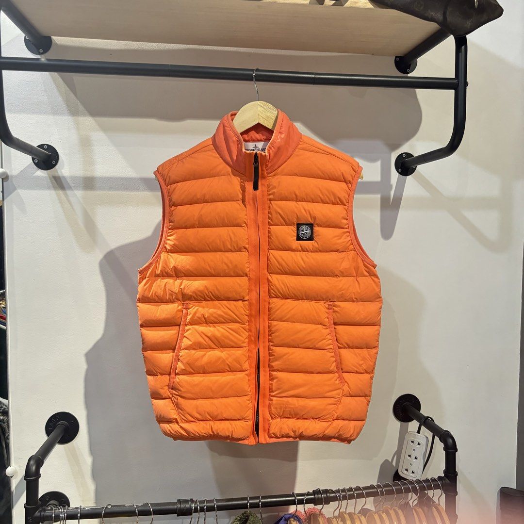 Stone Island Orange Down Puffer Vest XL (Category: Vests) located in Bambang. Submitted by heats777 (Listing ID 1470003798, Image 2). Description: - Brand: Stone Island - Item: Puffer Vest - Color: Bright Orange - Size: XL - Details: Quilted down design, full zip front, stand collar, two side pockets - Branding: Iconic compass logo patch on left chest - Condition: Clean inside and out.