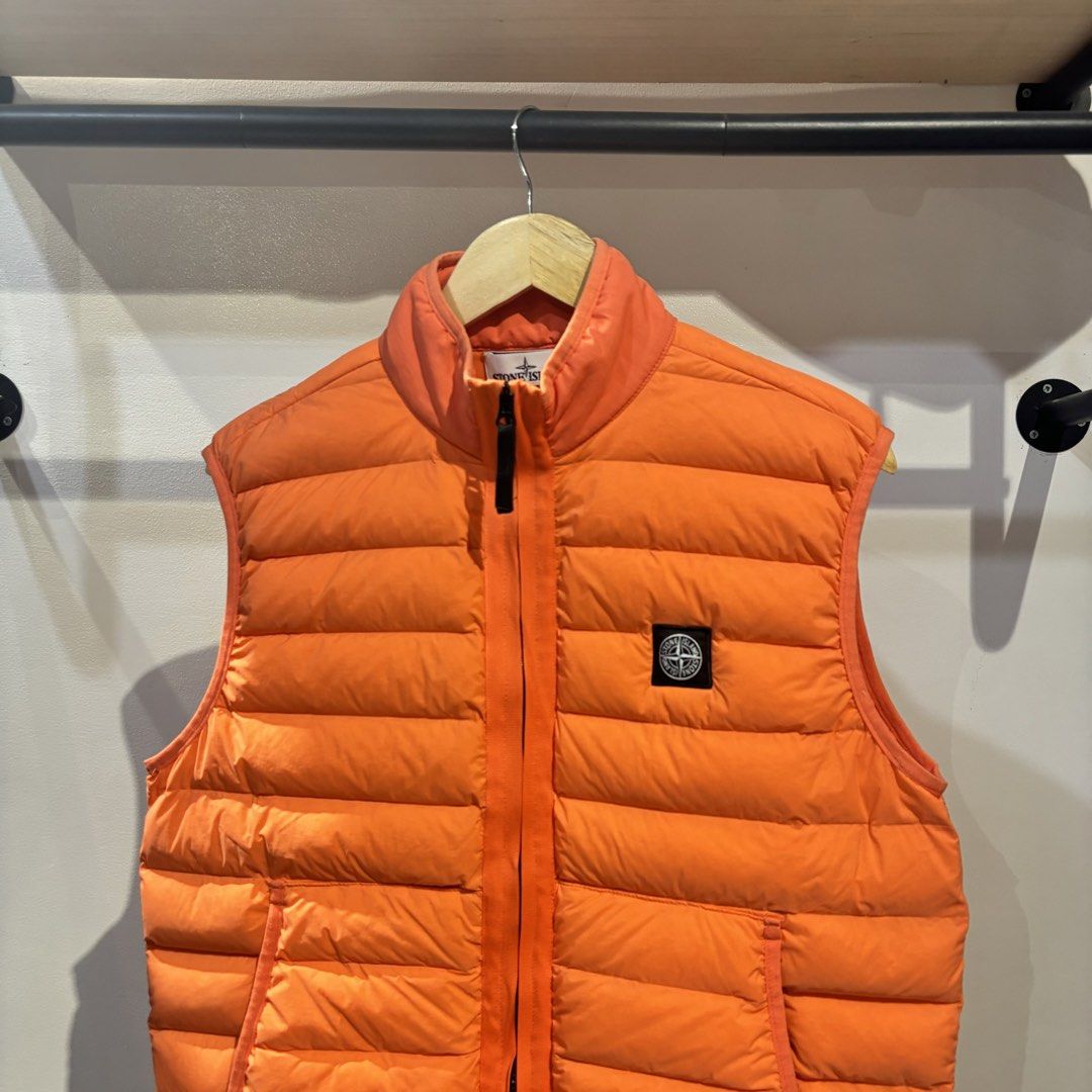 Stone Island Orange Down Puffer Vest XL (Category: Vests) located in Bambang. Submitted by heats777 (Listing ID 1470003798, Image 1). Description: - Brand: Stone Island - Item: Puffer Vest - Color: Bright Orange - Size: XL - Details: Quilted down design, full zip front, stand collar, two side pockets - Branding: Iconic compass logo patch on left chest - Condition: Clean inside and out.