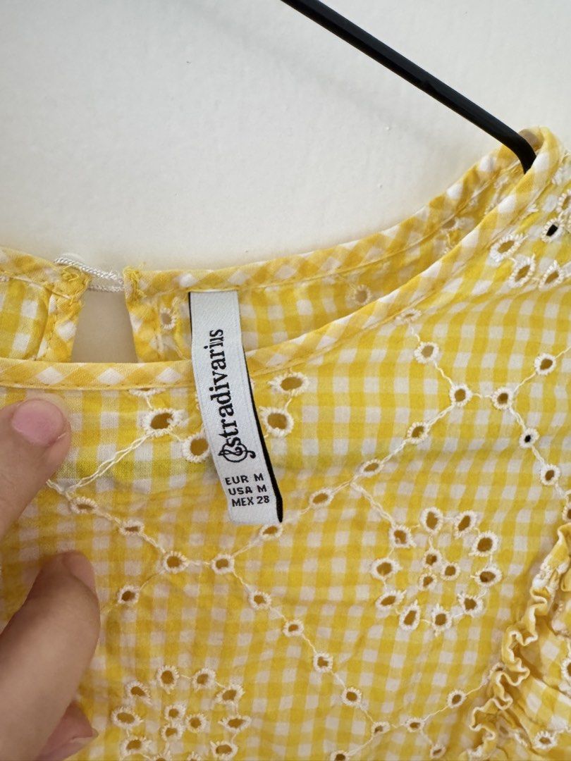 Stradivarius Yellow Gingham Eyelet Ruffle Sleeves Top (Category: Blouses) located in Mandaluyong City. Submitted by trinket.ph (Listing ID 1470141492, Image 2). Description: - Brand: Stradivarius - Size: EUR M / USA M / MEX 28 - Pattern: Yellow & white gingham with eyelet floral embroidery - Details: Ruffle cap sleeves, lightweight fabric - Condition: Great for warm weather.