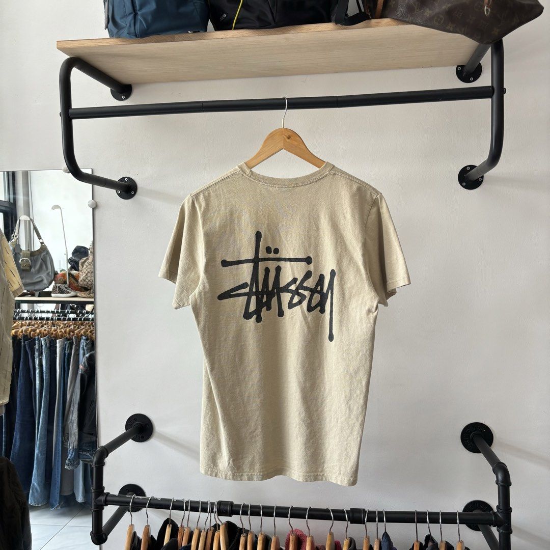 Stussy Basic Logo T-Shirt Sand Size S (Category: Tshirts & Polo Shirts ) located in Bambang. Submitted by heats777 (Listing ID 1470019233, Image 3). Description: - Brand: Stussy - Color: Beige Sand - Size: S (tag on collar) - Design: Small logo on chest, large iconic Stussy signature logo on back - Material: 100% cotton, made in Honduras - Neckline/Sleeves: Crew neck, short sleeves - Care: Machine wash cold.