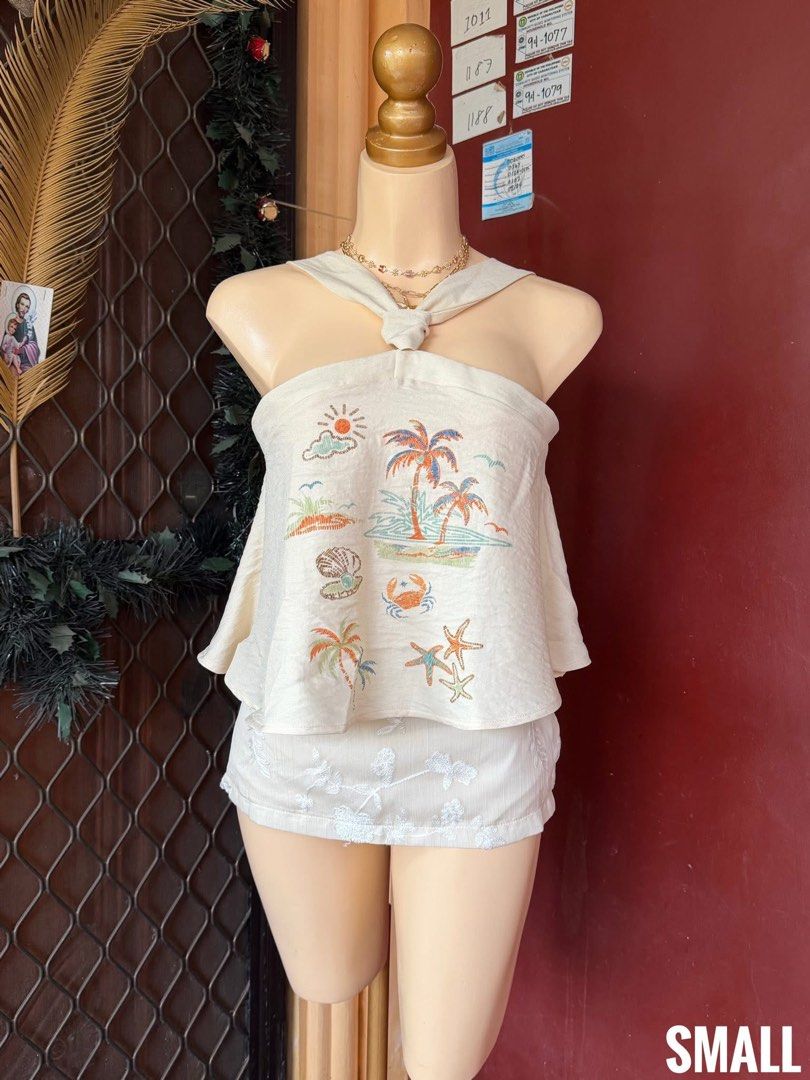 Summer Beach Embroidered Halter Top (Category: Sleeveless) located in Cabanatuan. Submitted by kyliedoscoped (Listing ID 1469969182, Image 1). Description: - Color: Cream - Style: Matching two-piece set (halter top and shorts) - Details: Colorful tropical embroidery on top, subtle white floral embroidery on shorts - Fabric: Lightweight, ideal for warm weather and beach getaways - Fit: Fits small.