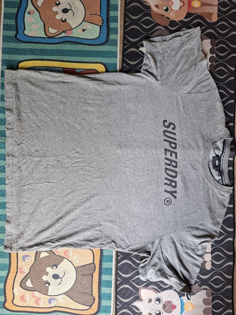 Superdry Grey T-shirt Size XL (Category: Tshirts & Polo Shirts ) located in San Francisco. Submitted by manu2025 (Listing ID 1470140016, Image 1). Description: - Brand: Superdry - Color: Grey - Size: XL (Standard fit) - Measurements: ~24.5" chest across, ~28" length - Design: Short sleeves, crew neck, large black chest logo, and upper back stripes - Meetup/Shipping available across the Philippines.
