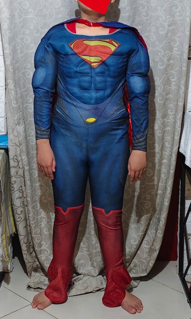 Superman Muscle Costume With Cape (Category: Babies & Kids Fashion) located in Manila. Submitted by duffy-080 (Listing ID 1470084402, Image 1). Description: - Superman costume with built-in muscle padding on chest and arms - Classic red and blue jumpsuit design with attached red boot covers - Includes detachable blue cape with the iconic yellow Superman shield logo - Easy-to-wear back zipper closure - Perfect for dress-up parties, Halloween, tric
