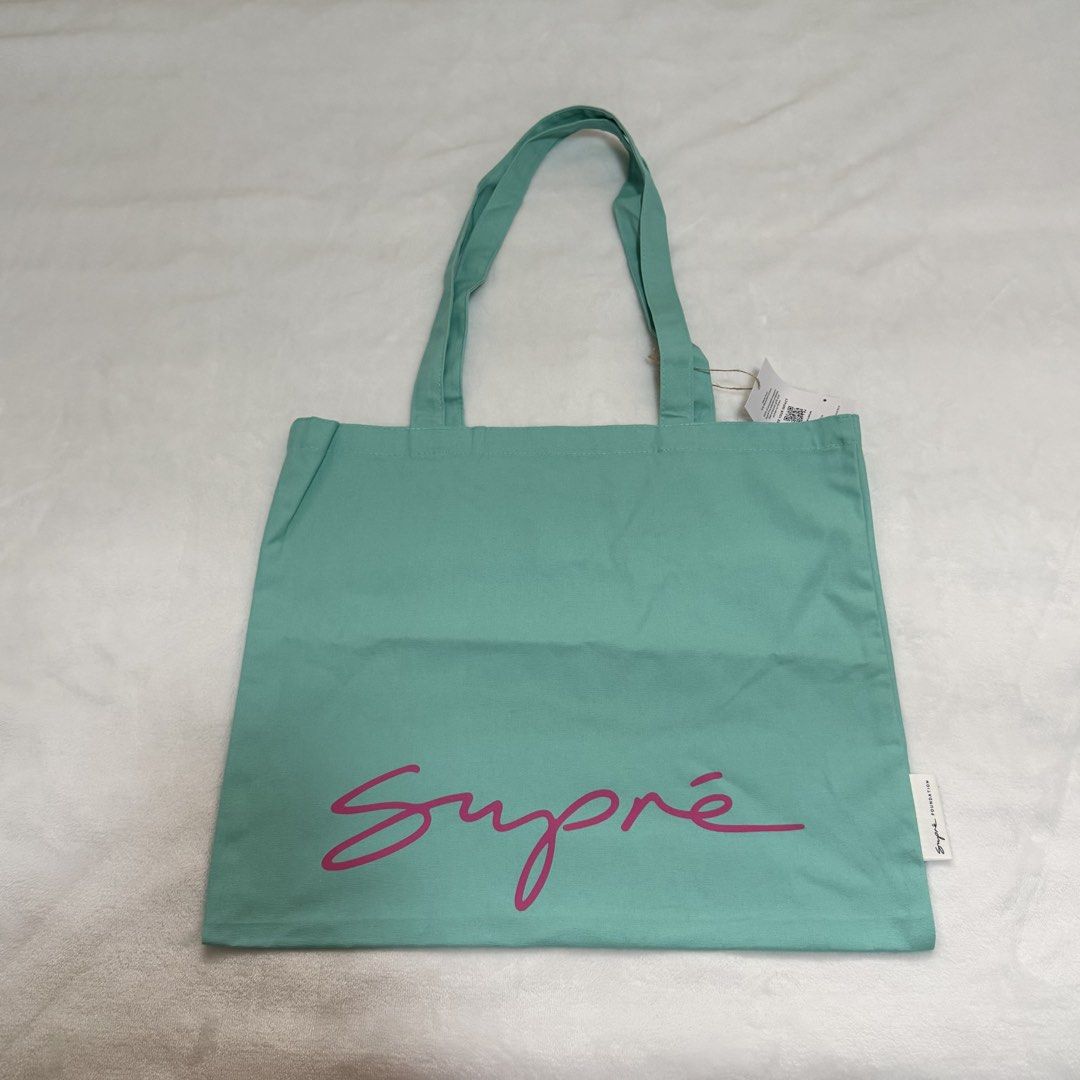Supré Tote Bag (Category: Tote Bags) located in Quezon City. Submitted by lovedbysia (Listing ID 1469976551, Image 1). Description: - Brand new with tags still attached - Color: Mint green with a bright pink Supré logo - Great for daily shopping, school, work, or running errands.