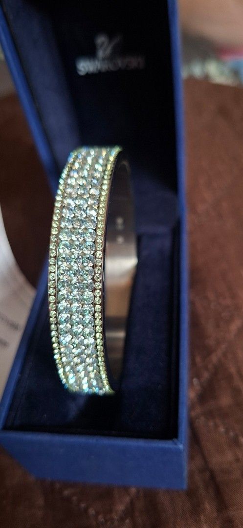 Swarovski Crystal Bangle Size M (Category: Bracelets) located in Cavite. Submitted by 10ferjenn (Listing ID 1469981803, Image 1). Description: - Authentic Swarovski crystal bangle - Size: M (stamped on inner band) - Multi-row pave crystals that sparkle heavily under light - Condition: Brand new/unworn, kept safely in storage - Inclusions: Original dark blue branded box and store receipt tag from Paris.