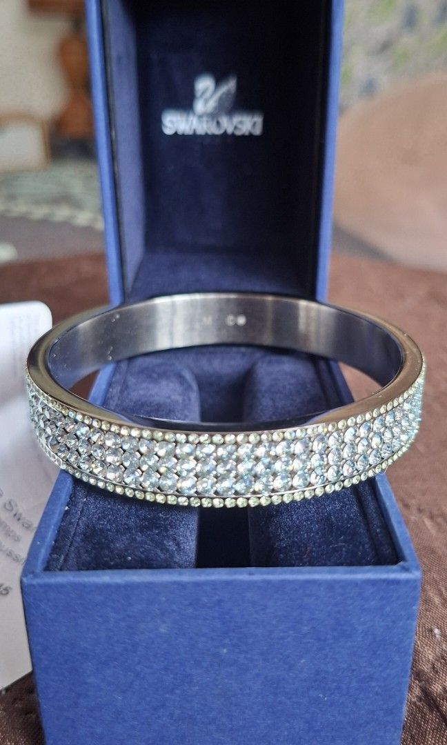 Swarovski Crystal Bangle Size M (Category: Bracelets) located in Cavite. Submitted by 10ferjenn (Listing ID 1469981803, Image 2). Description: - Authentic Swarovski crystal bangle - Size: M (stamped on inner band) - Multi-row pave crystals that sparkle heavily under light - Condition: Brand new/unworn, kept safely in storage - Inclusions: Original dark blue branded box and store receipt tag from Paris.