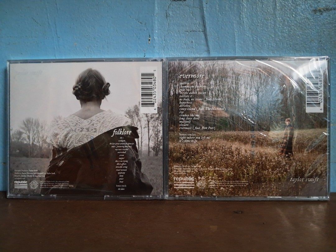 Taylor Swift Folklore and Evermore Signed CD Bundle (Category: CDs & DVDs) located in Nabua. Submitted by bejeweled_13 (Listing ID 1470018627, Image 2). Description: - Authentic Taylor Swift studio albums: folklore and evermore - Genuine hand-signed autographs in black marker on the front covers - Standard jewel case releases from Republic Records - Includes original parental advisory stickers on shrink wrap - Back tracklists and barcodes fully v
