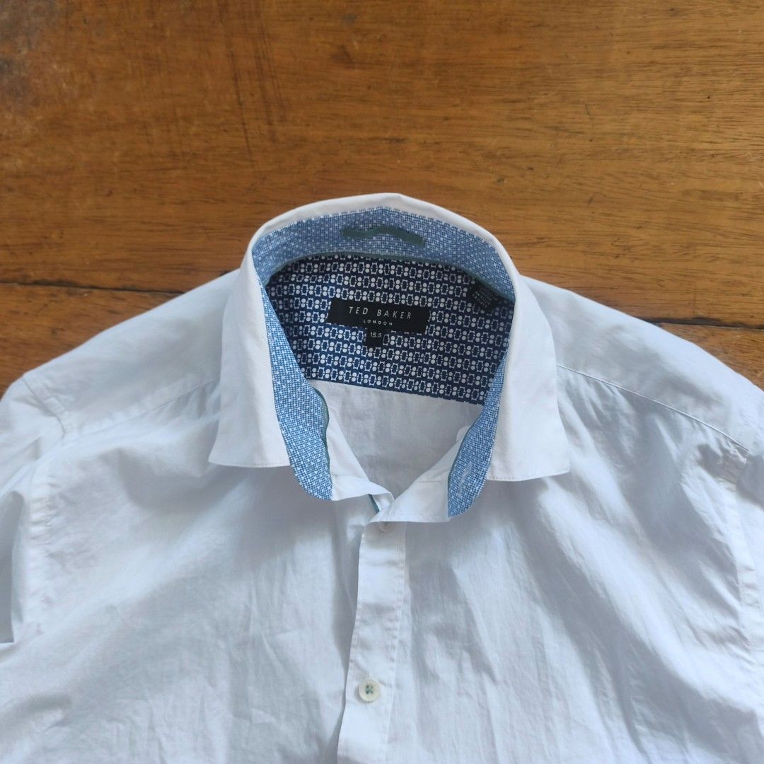 Ted Baker dress shirt (Category: Formal Shirts) located in Tayabas. Submitted by cat.b0i (Listing ID 1470033561, Image 2). Description: Size on tag: 15.5 Fitting: Men - M-L Women - L ‎Length: 27 ‎Width: 19.5 ‎Shoulder: 17 ‎Arm Space: 9 ‎Sleeve Length: 25.5 ‎ ‎Color: White with accents Color Rate: 9.2 ‎Material: 100% cotton properties: ‎Issues: minor distressing on accent inside collar (see pic 3) ‎Condition: great.