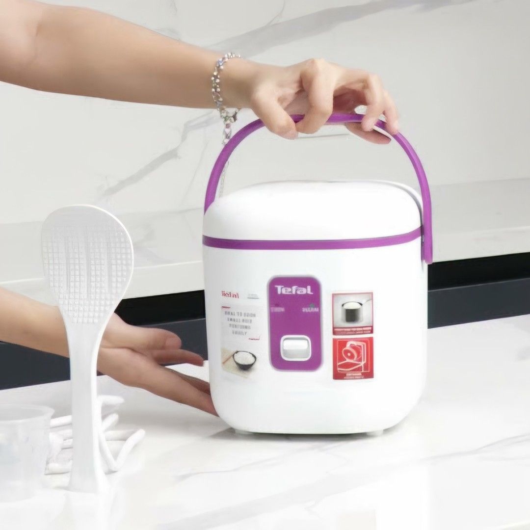Tefal Mini Rice Cooker 0.4L / 2 cups (Category: Cookers) located in Quezon City. Submitted by reply_1982 (Listing ID 1469952751, Image 2). Description: - Compact Tefal rice cooker in a stylish white and purple design - Ideal for small kitchens, dorm rooms, or single servings - Simple one-touch operation with cook and warm indicator lights - Convenient carrying handle on top for easy portability.