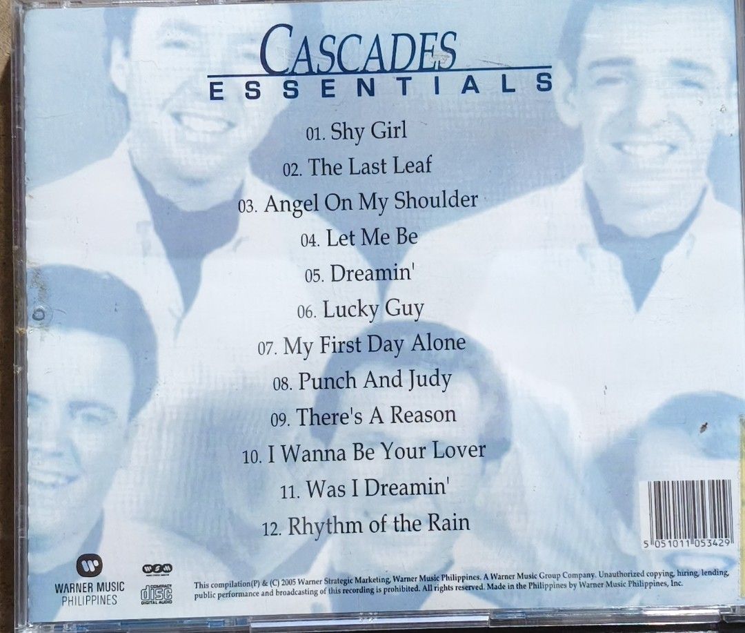 The Cascades Essentials CD Album (Category: CDs & DVDs) located in Manila. Submitted by ruelcabrer77078 (Listing ID 1470093159, Image 3). Description: - Artist & Album: The Cascades - Essentials - Release: Warner Music Philippines, 2005 - Tracks: 12 classic hits including Shy Girl, Rhythm of the Rain, Dreamin', and The Last Leaf - Format: Standard jewel case - Inclusions: Original disc and inserts with tracklist on the back cover - Condition: Goo