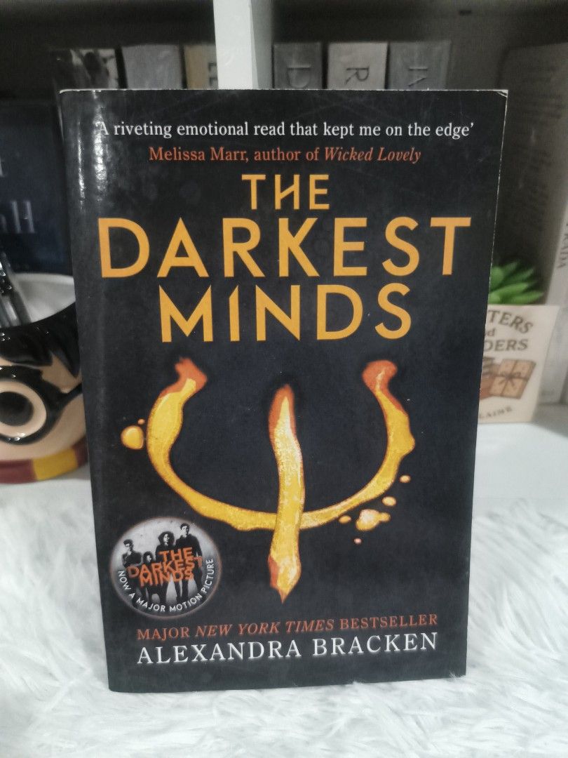 The Darkest Minds by Alexandra Bracken (Category: Storybooks) located in Cabuyao City. Submitted by chaptersandwonders143 (Listing ID 1469997940, Image 1). Description: - Title: The Darkest Minds (Book 1) - Author: Alexandra Bracken - Publisher: Quercus - Edition: Paperback with movie tie-in cover & yellow psych symbol - Condition: Preloved; pages show natural tanning, spine has reading creases (intact), and original price tag on the back cover -