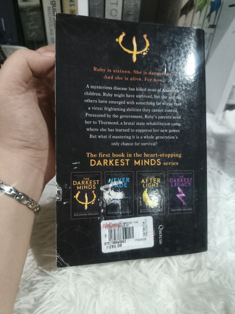 The Darkest Minds by Alexandra Bracken (Category: Storybooks) located in Cabuyao City. Submitted by chaptersandwonders143 (Listing ID 1469997940, Image 3). Description: - Title: The Darkest Minds (Book 1) - Author: Alexandra Bracken - Publisher: Quercus - Edition: Paperback with movie tie-in cover & yellow psych symbol - Condition: Preloved; pages show natural tanning, spine has reading creases (intact), and original price tag on the back cover -
