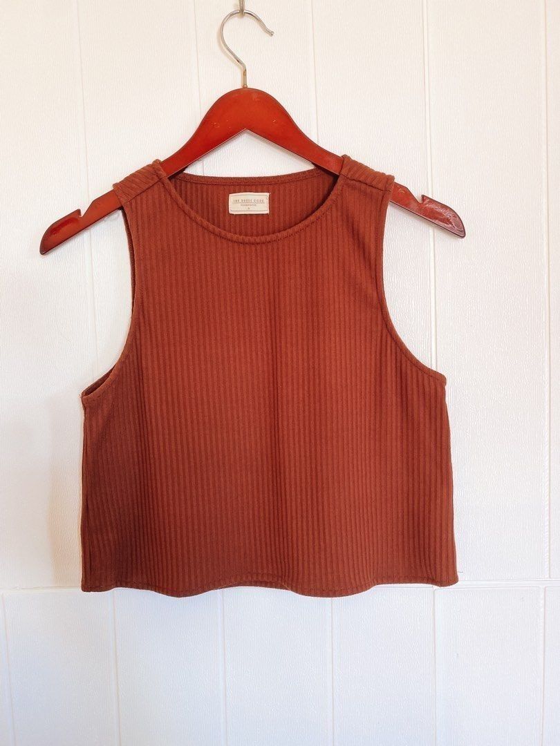 The Dress Code Penshoppe Ribbed Crop Top Size S (Category: Sleeveless) located in Calamba. Submitted by iam.hides (Listing ID 1470032193, Image 2). Description: - Brand: The Dress Code by Penshoppe - Size: Small - Color: Rust brown - Material: Soft, stretchy ribbed fabric - Design: Sleeveless with a round neckline - Fit: Crop top length, ideal for high-waisted denim or skirts - Condition: Clean interior tag intact, well-maintained.