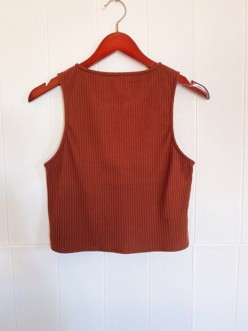 The Dress Code Penshoppe Ribbed Crop Top Size S (Category: Sleeveless) located in Calamba. Submitted by iam.hides (Listing ID 1470032193, Image 3). Description: - Brand: The Dress Code by Penshoppe - Size: Small - Color: Rust brown - Material: Soft, stretchy ribbed fabric - Design: Sleeveless with a round neckline - Fit: Crop top length, ideal for high-waisted denim or skirts - Condition: Clean interior tag intact, well-maintained.