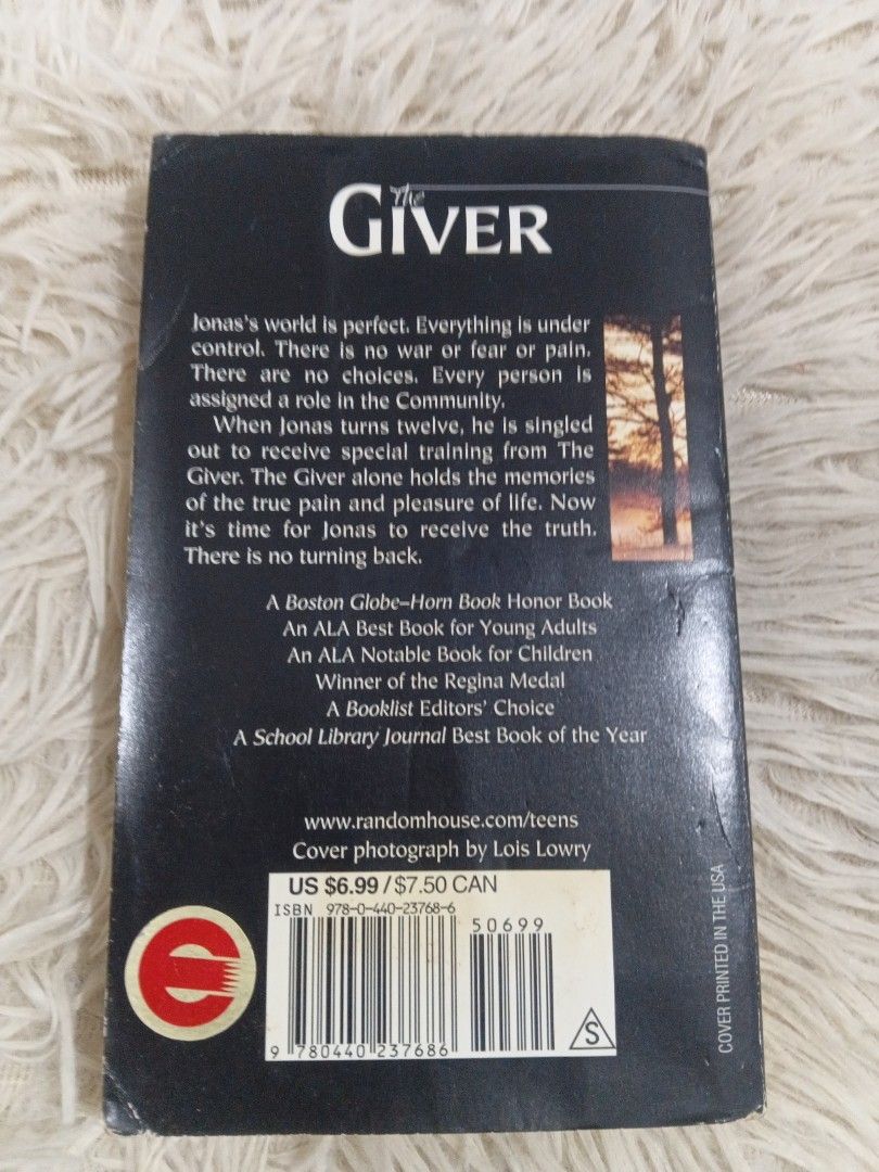 The Giver by Lois Lowry Laurel-Leaf Paperback (Category: Storybooks) located in Cavite. Submitted by nathstelein_finds (Listing ID 1470118682, Image 2). Description: - Title & Author: The Giver by Lois Lowry - Edition & Format: Laurel-Leaf paperback edition with black cover - Genre: Classic dystopian novel - Condition: Pages have natural yellowing and age spots around the edges; spine is intact with standard shelf wear - Details: ISBN barcode vis