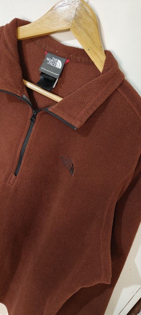The North Face 1/4 Zip Fleece Pullover Brown (Category: Coats, Jackets and Outerwear) located in Bulacan. Submitted by adrian2325 (Listing ID 1470111744, Image 3). Description: - Brand: The North Face - Style: Quarter-zip fleece with high collar and zipper pull - Color: Deep brown - Material: Warm and soft Polartec fleece - Size: Tagged meduim (Approx. 26 x 23 inches) - Details: Embroidered logo on the chest - Condition: Great layering piece for 