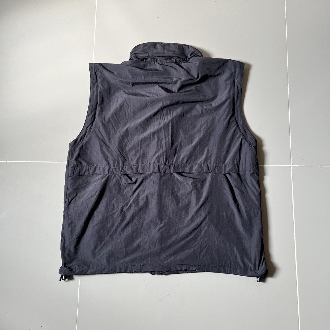 The North Face Black Vest Size 100 M (Category: Vests) located in Toledo. Submitted by collective_stuff (Listing ID 1469957995, Image 3). Description: - Brand: The North Face - Color: Dark Grey - Size: 100 (Fits like Medium) - Material: Durable nylon with breathable mesh inner lining - Closure: Full zip front - Pockets: Multiple front pockets plus a secure zippered chest pocket - Fit: Adjustable drawstring hem - Ideal for: Outdoor adventures, hik