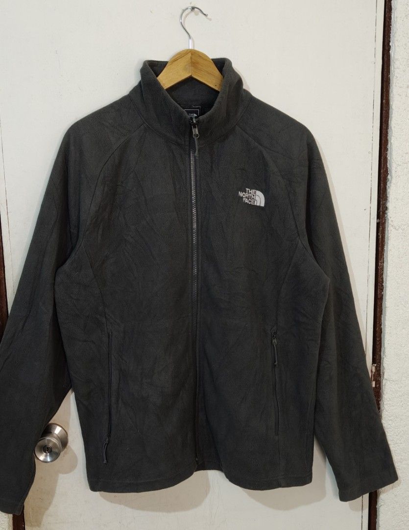 The North Face Dark Grey Fleece Jacket (Category: Coats, Jackets and Outerwear) located in Bulacan. Submitted by adrian2325 (Listing ID 1470111871, Image 2). Description: - Brand: The North Face - Color: Dark Grey - Material: Soft fleece (inside and out) - Fit: Regular - Features: Full zip closure, secure side pockets, high wind-blocking collar - Branding: Embroidered white logo on chest - Condition: Excellent outdoor piece for cold weather.