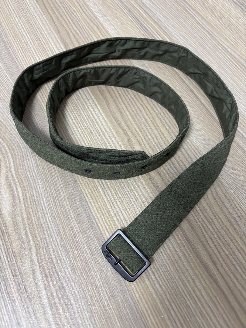 The North Face Green Fabric Belt (Category: Belts) located in Silang. Submitted by lakasthrift1577 (Listing ID 1470074288, Image 2). Description: - Brand: The North Face - Color: Green fabric with dark metal hardware - Design: Classic military style with eyelet holes along the strap - Comfort: Features a smooth inner lining for comfortable wear - Durability: Sturdy construction built to last - Versatility: Great accessory for casual everyday wear