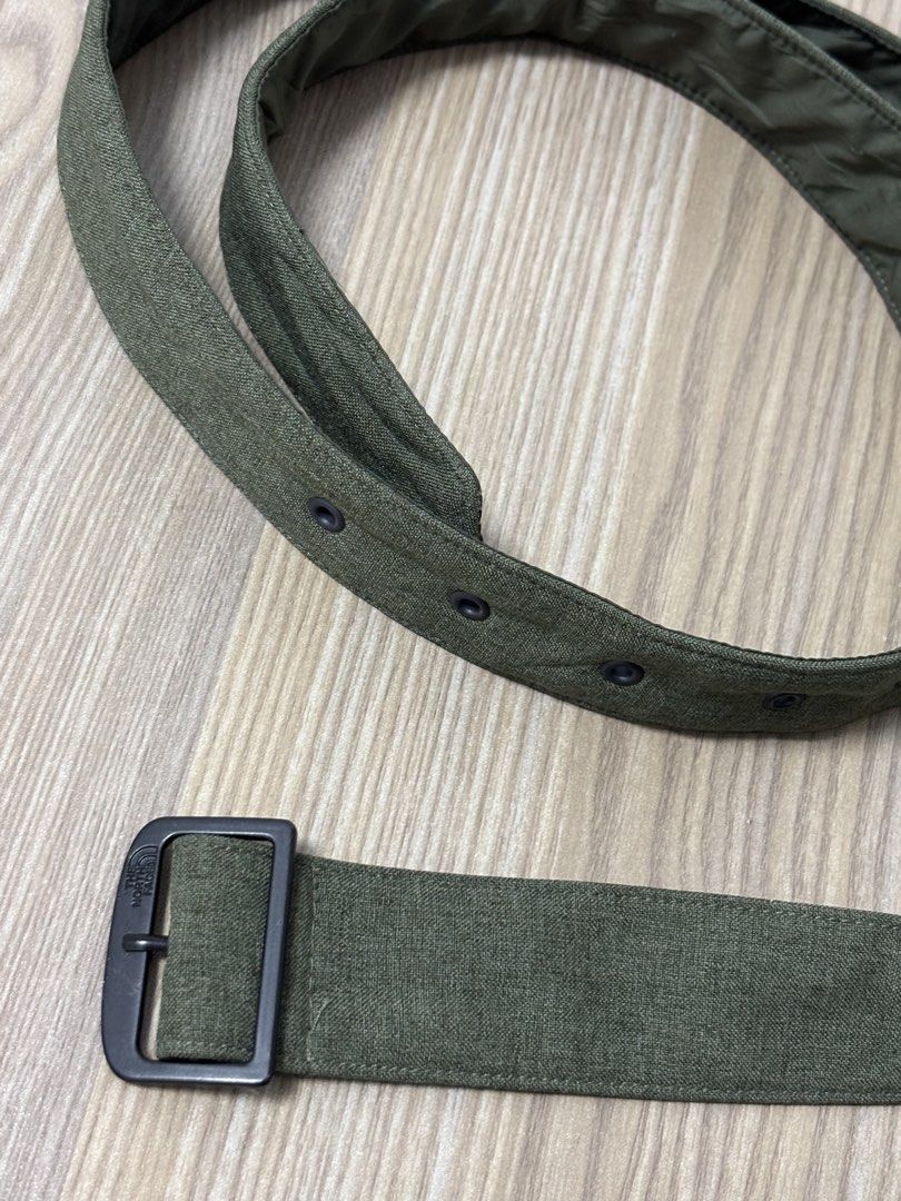 The North Face Green Fabric Belt (Category: Belts) located in Silang. Submitted by lakasthrift1577 (Listing ID 1470074288, Image 3). Description: - Brand: The North Face - Color: Green fabric with dark metal hardware - Design: Classic military style with eyelet holes along the strap - Comfort: Features a smooth inner lining for comfortable wear - Durability: Sturdy construction built to last - Versatility: Great accessory for casual everyday wear