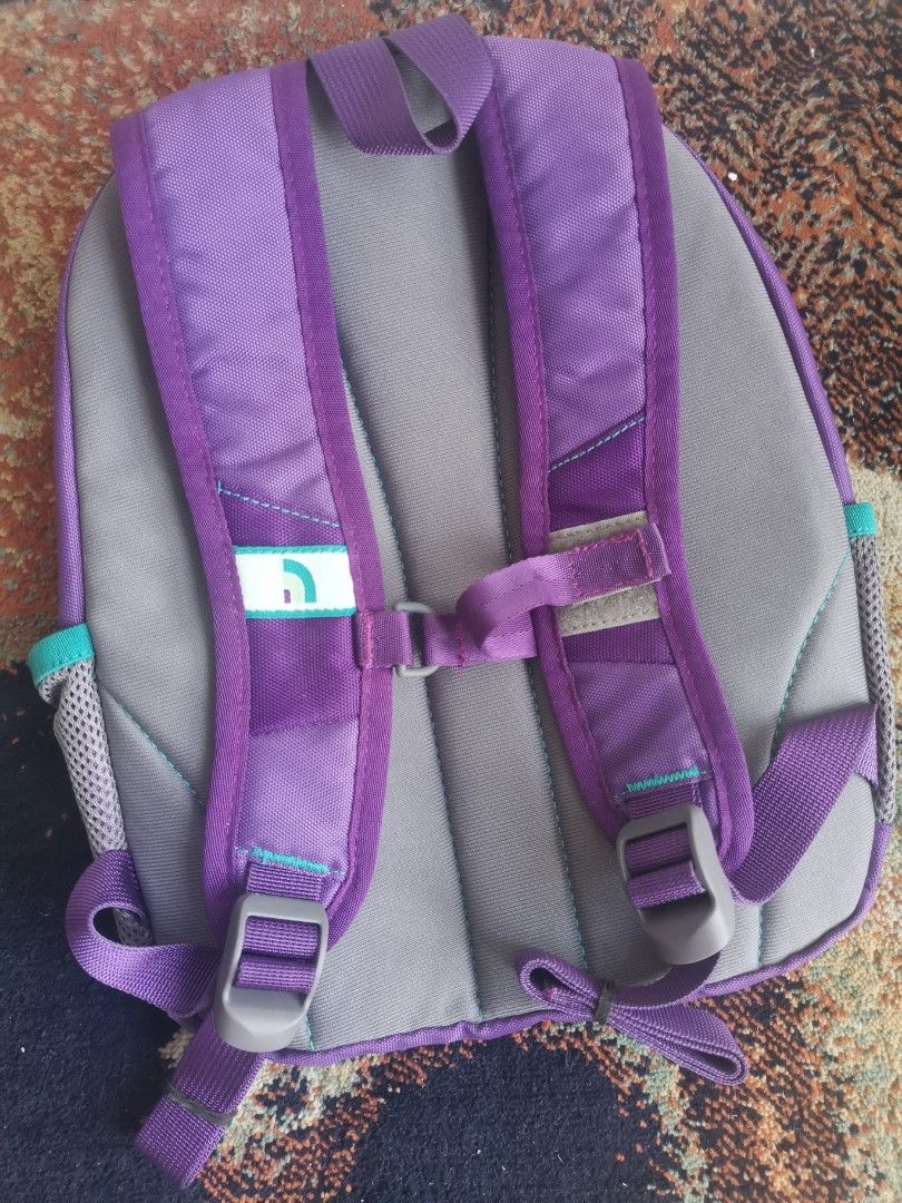 The North Face Homeslice Purple Backpack (Category: Backpacks) located in Quezon City. Submitted by trendsites.manila (Listing ID 1470108084, Image 2). Description: - Brand: The North Face (Homeslice backpack) - Condition: Brand new with original store tag attached - Color/Design: Purple with teal accents, grey mesh pockets, and a paint splatter pattern lining - Comfort features: Padded shoulder straps and adjustable chest buckle - Material: 100%