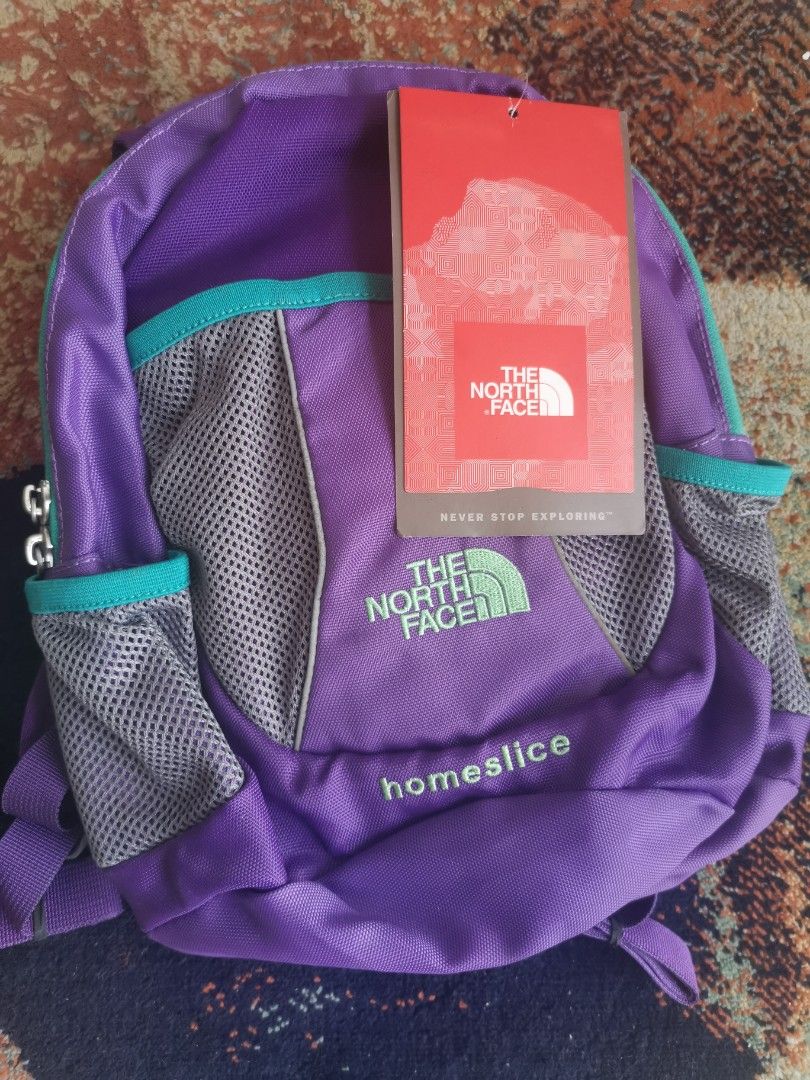 The North Face Homeslice Purple Backpack (Category: Backpacks) located in Quezon City. Submitted by trendsites.manila (Listing ID 1470108084, Image 1). Description: - Brand: The North Face (Homeslice backpack) - Condition: Brand new with original store tag attached - Color/Design: Purple with teal accents, grey mesh pockets, and a paint splatter pattern lining - Comfort features: Padded shoulder straps and adjustable chest buckle - Material: 100%
