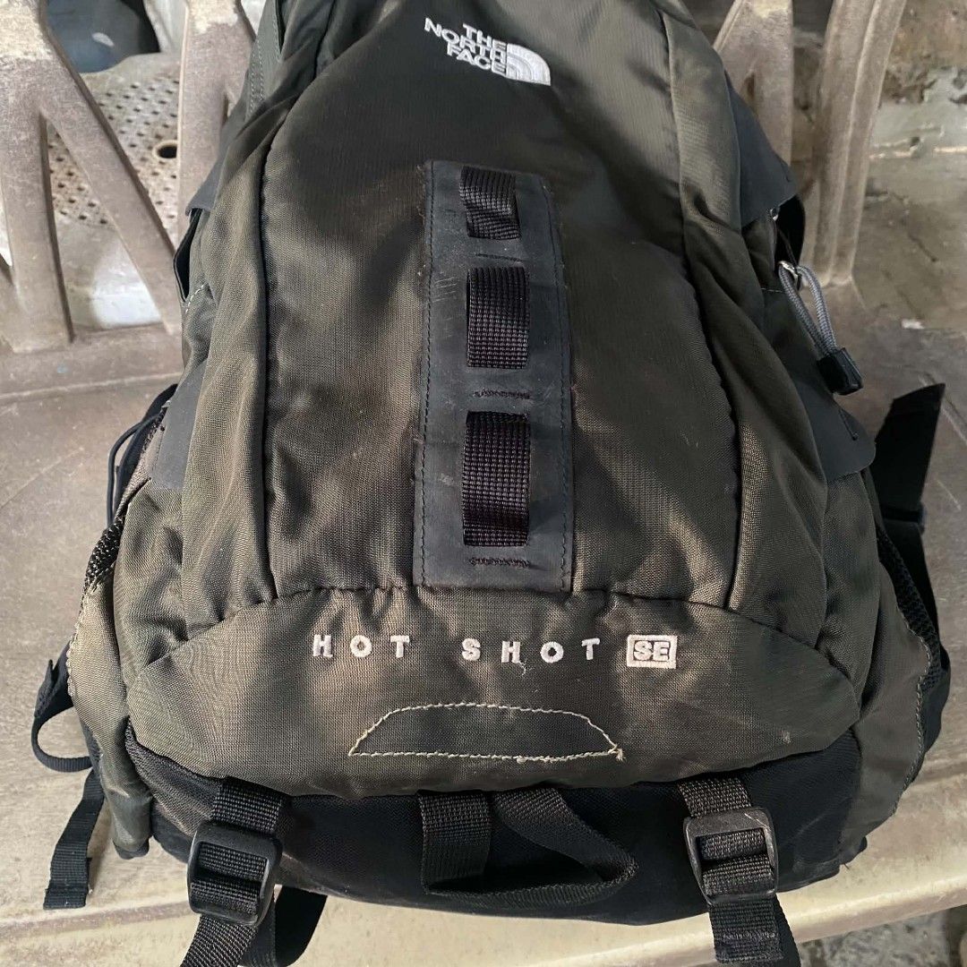The North Face Hot Shot SE Backpack Olive Green (Category: Backpacks) located in Manila. Submitted by _mrkeith (Listing ID 1470048500, Image 2). Description: - Brand: The North Face - Model: Hot Shot SE Backpack - Color: Olive Green - Condition: Excellent, clean interior with smooth zippers - Features: Durable fabric, multiple compartments, compression straps, and mesh side pockets - Comfort: Padded back panel, padded shoulder straps, and adjusta