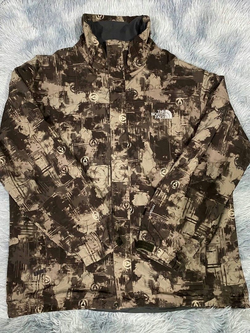 The North Face HyVent Men's Jacket XL (Category: Coats, Jackets and Outerwear) located in Manila. Submitted by gemfinds650 (Listing ID 1470101638, Image 1). Description: - Brand: The North Face - Size: Men's XL - Design: Unique brown & grey all-over camo print with white embroidered logos on chest and sleeve - Technology: HyVent waterproof fabric for ultimate weather protection - Features: Zip-up front with high collar for extra warmth - Conditio