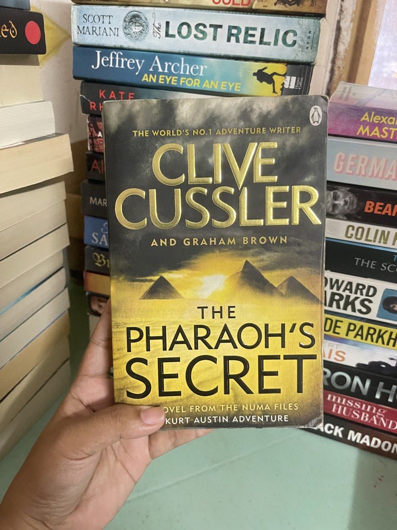 The Pharaoh’s Secret by Clive Cussler (Category: Storybooks) located in General Trias. Submitted by kwinay.28 (Listing ID 1470022876, Image 1). Description: UK Paperback with spine creases and lightly tanned edges Good condition Thriller / Historical fiction.