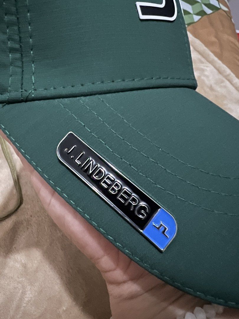 Titleist and j.lindeberg Golf Caps (Category: Caps & Hats) located in Binan City. Submitted by thetidyqueen (Listing ID 1470077296, Image 3). Description: - P800 each - Cap 1: White Titleist mesh trucker hat with black embroidered logo - Cap 2: Dark green J.Lindeberg cap featuring front bridge logo, perforated side branding, and metal plaque tag on the brim - Both items are clean and well-maintained - Great addition to any golfer's wardrobe - Fla