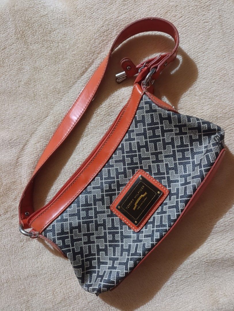 Tommy Hilfiger Monogram Shoulder Bag Orange Black (Category: Shoulder Bags) located in Leyte. Submitted by itz_zy (Listing ID 1470099079, Image 1). Description: 👜 PRELOVED TOMMY HILFIGER BAG 🤎 ✨ Classic design | Vintage-inspired | Timeless style Selling this preloved Tommy Hilfiger-branded bag featuring a black-and-beige geometric pattern with reddish-brown accents. Its classic design makes it easy to pair with casual outfits, jeans, dresses, a