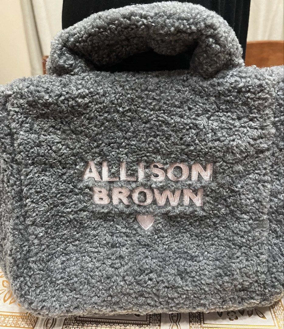 Top handle bag (Category: Tote Bags) located in Bacoor. Submitted by ayit. (Listing ID 1470060179, Image 1). Description: Orig once used japan gling - Color: Gray with pink embroidery - Material: Soft plush fleece / faux shearling - Features: 'ALLISON BROWN' text and cute heart embroidery on the front - Interior: Light pink lining with convenient slip pockets - Closure: Secure button snap - Style: Chic top handle tote bag, perfect for casual outi