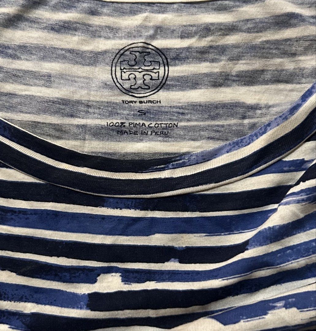 TORY BURCH (Category: Shirts) located in Davao. Submitted by sart0ria85 (Listing ID 1470107581, Image 3). Description: Blue and white striped short-sleeve ; Classic crew neck, large white T-logo graphic on the chest. Made out of the luxurious 100% PIMA COTTON. MADE IN PERU 🇵🇪 SMALL. Size 4 EXCELLENT CONDITION (95/100).