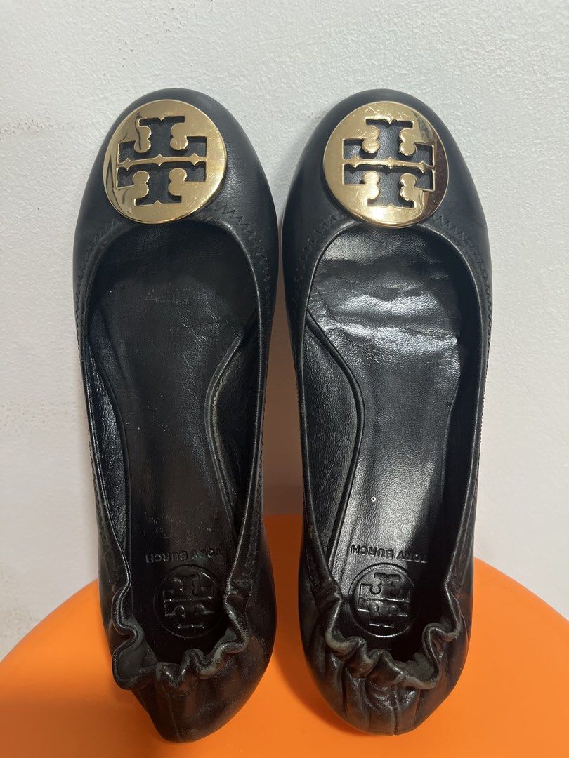 Tory Burch Black Leather Logo Ballet Flats (Category: Flats & Sandals) located in Valenzuela. Submitted by sofiasticated.decluttering (Listing ID 1470000939, Image 3). Description: - Brand: Tory Burch - Color: Classic Black - Material: Genuine Leather - Details: Gold-tone logo plaque on toe, elasticized topline for a comfortable slip-on fit - Condition: Pre-loved with visible wear on leather/soles and a minor scuff near the front edge (please che