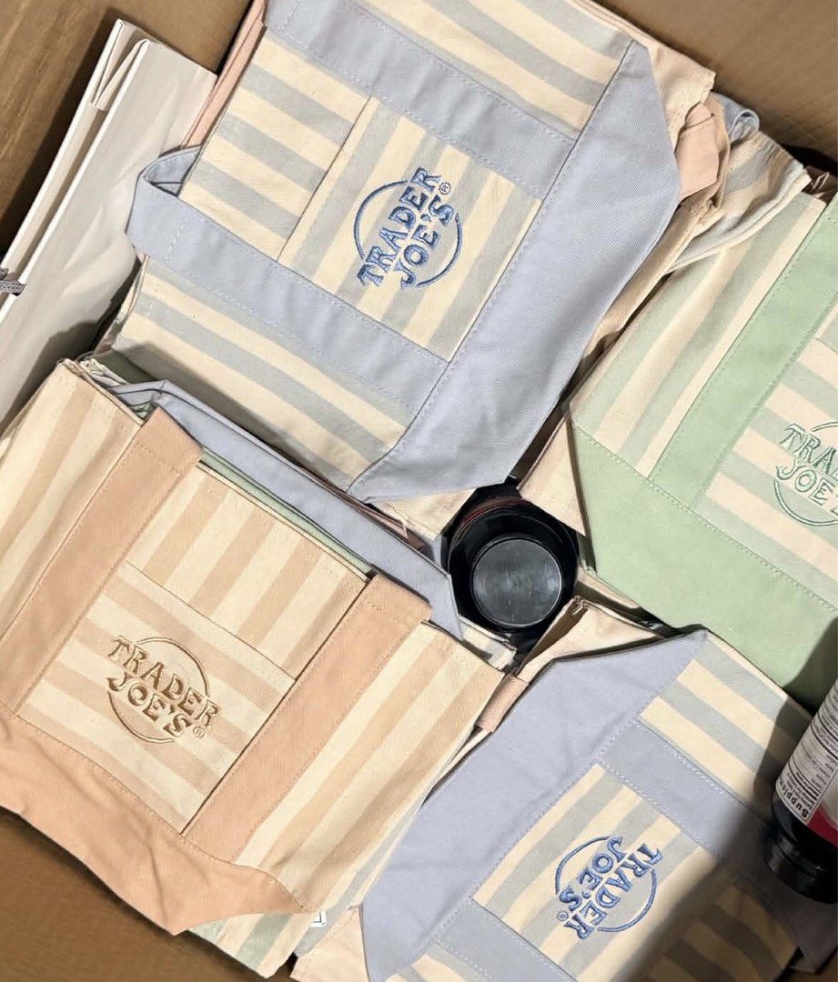 Trader Joe's Striped Mini Canvas Tote Bag (Category: Tote Bags) located in Manila. Submitted by tonettesells (Listing ID 1469949746, Image 2). Description: - 100% Authentic Trader Joe's Mini Canvas Tote Bag - Available pastel striped colors: Orange, Green, Blue, and Pink - Made with heavy-duty canvas material and sturdy handles - Features a convenient front pocket with embroidered logo - Brand new with tags (BNWT) attached.
